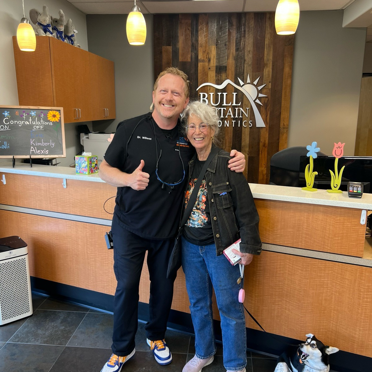 Dr. Bryce Wilcox, orthodontist in Tigard, smiling with a patient at Bull Mountain Orthodontics.