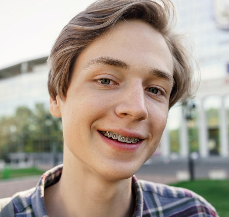 Teenager smiling with braces, showcasing orthodontic treatment in Tigard.
