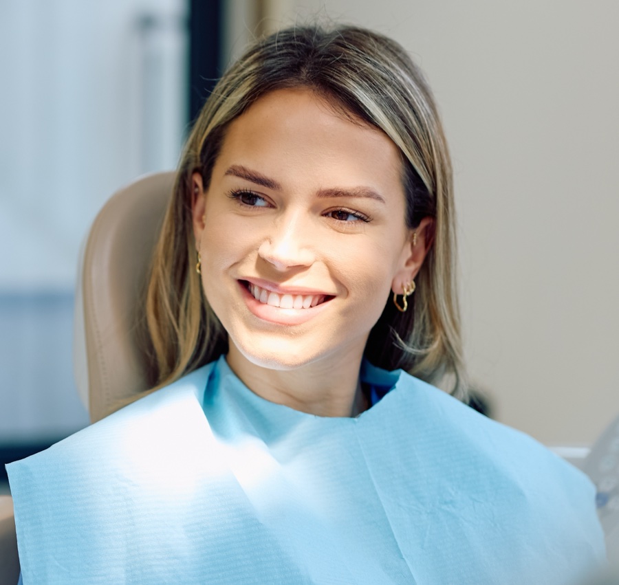 Smiling patient in dental chair, showcasing healthy smile and orthodontic care in Tigard.
